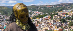 Skull statue in front of Guanajuato view