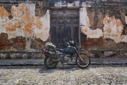 DR650 in front of old wall in Antigua